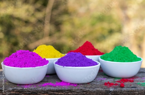 Indian Holi Festival Organic Color or Gulal in White Bowls on Wooden Background with Selective Focus in Horizontal Orientation