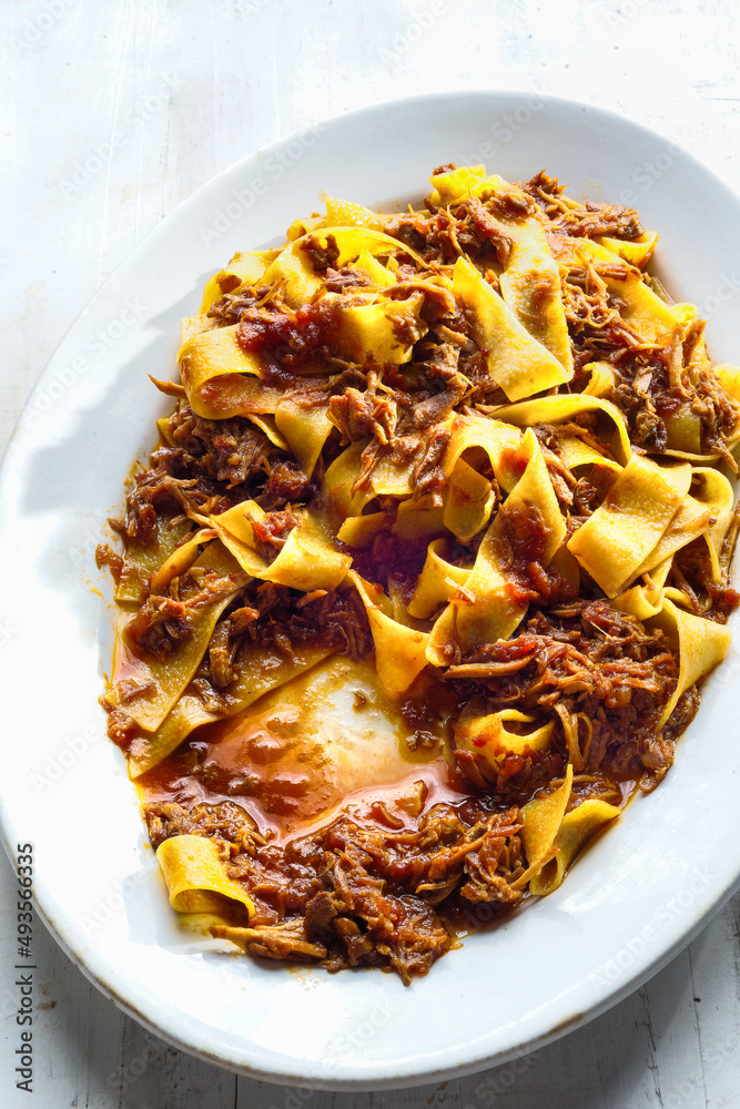 rustic italian pappardelle pasta in bolognese sauce