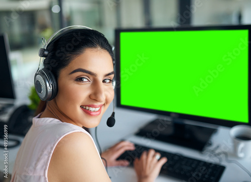 You know who to contact when in need. Portrait of a young woman working on a computer in a call centre.