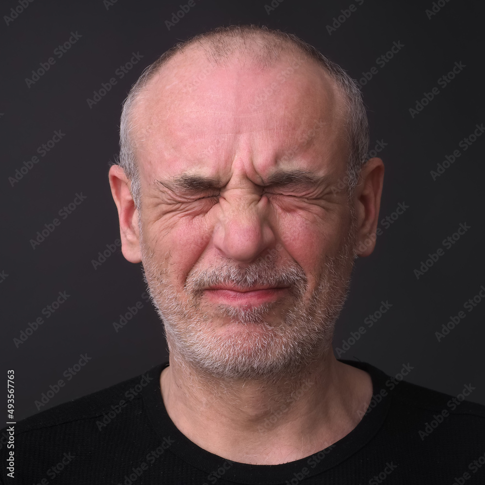 man with closed eyes emotion of pain on his face man with closed eyes emotion of pain on his face