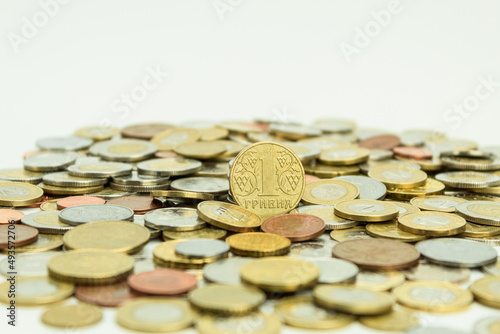 Pile of coins of different denominations on a white background