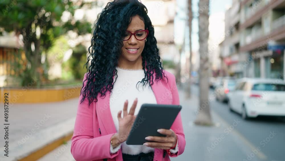 African american woman executive smiling confident using touchpad at park African american woman executive smiling confident using touchpad at park