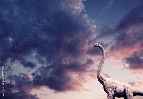 Dinosaur statue on a violet sky.  © photo_HYANG