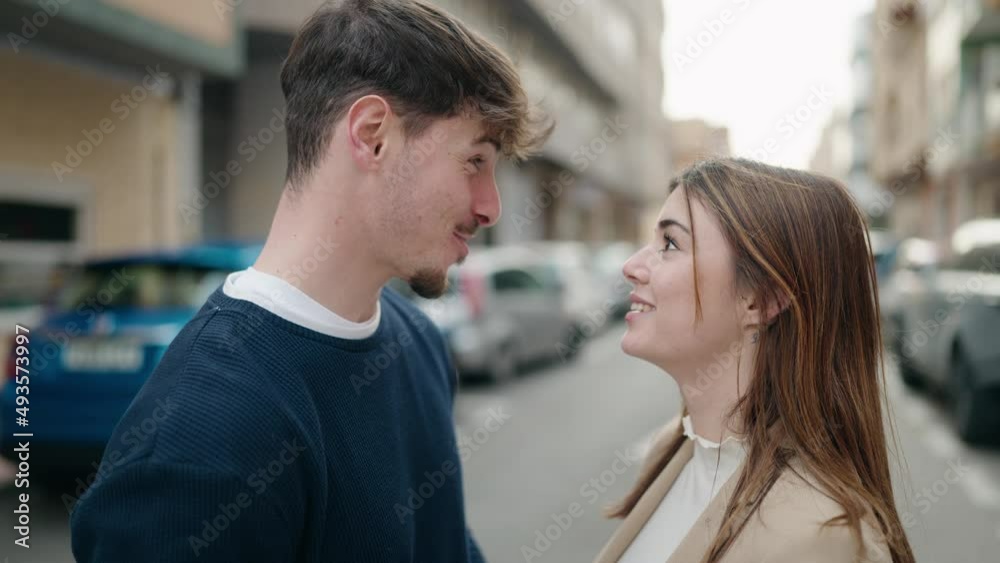 Young couple smiling confident speaking at street Young couple smiling confident speaking at street