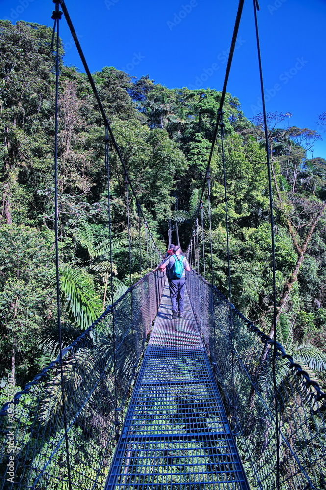 Crossing a hanging bridge in Costa Rica rainforest