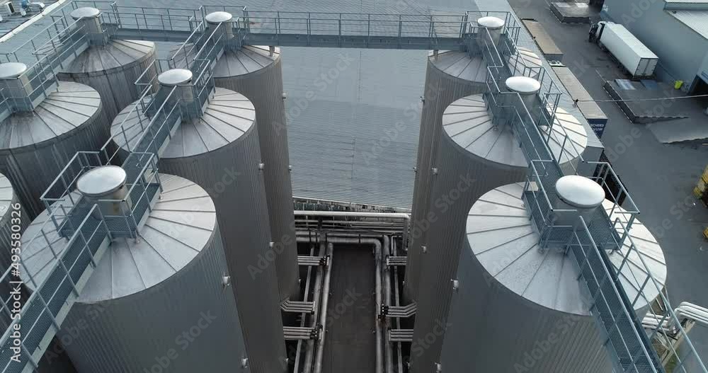 Beer factory, Juice and limonade factory. Manufacturing. Huge Barrels. Aerial drone shot	