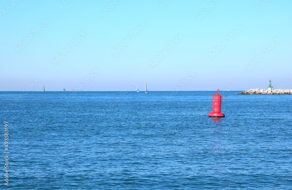 Fototapeta premium red buoy in the middle of the sea to indicate the presence of the dam on boats near the island of Venice in Italy