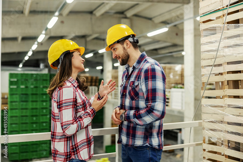 Colleagues at work flirt in the isolate space of the warehouse. 