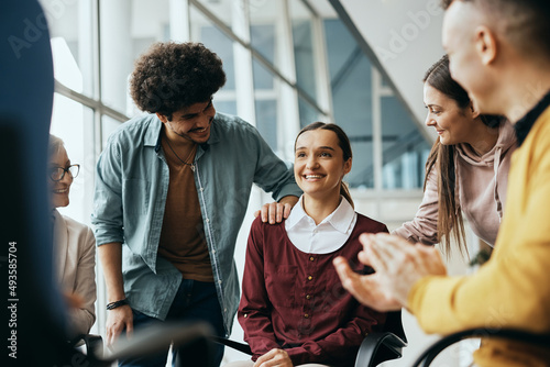 Young happy woman receives support from attenders of group therapy at mental health center. photo