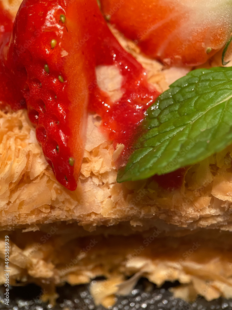 Napoleon cake with a pieces of fresh strawberries close up with selective focus Napoleon cake with a pieces of fresh strawberries close up with selective focus
