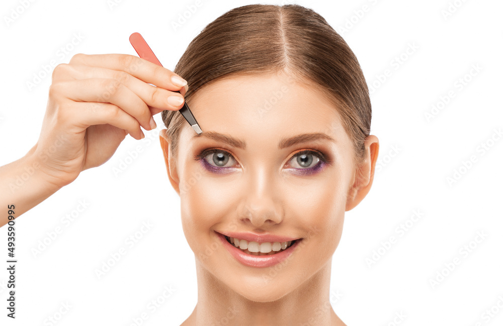 Makeup artist combs eyebrows in a beauty salon. Professional make-up and cosmetic skin care. Makeup artist combs eyebrows in a beauty salon. Professional make-up and cosmetic skin care.