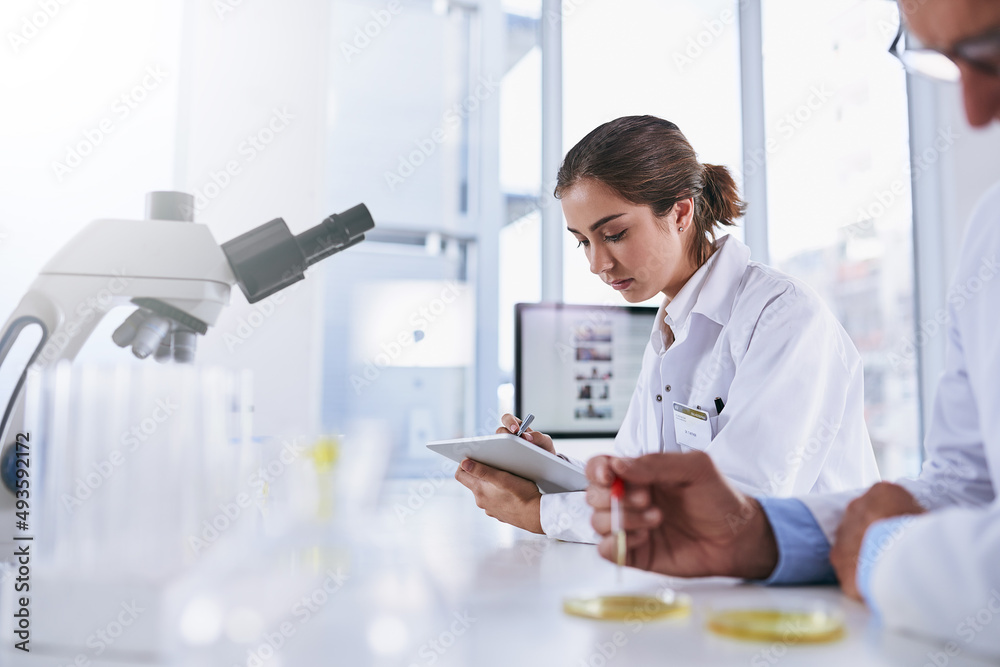 Its a high-tech workspace. Shot of two scientists working in a lab. Its a high-tech workspace. Shot of two scientists working in a lab.