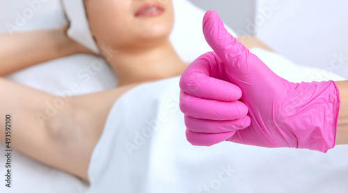 Elos epilation hair removal procedure on a woman   s body. Beautician doing laser rejuvenation in a beauty salon. Removing unwanted body hair. Hardware ipl cosmetology