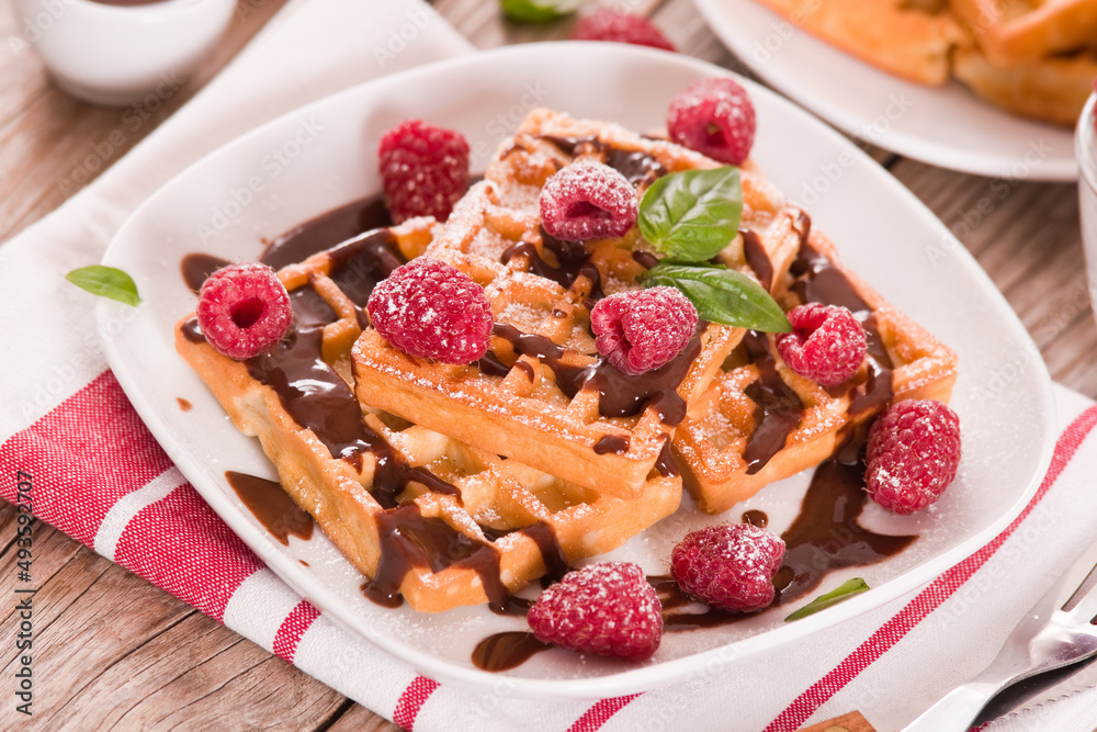 Waffles with raspberries and chocolate cream. Waffles with raspberries and chocolate cream.