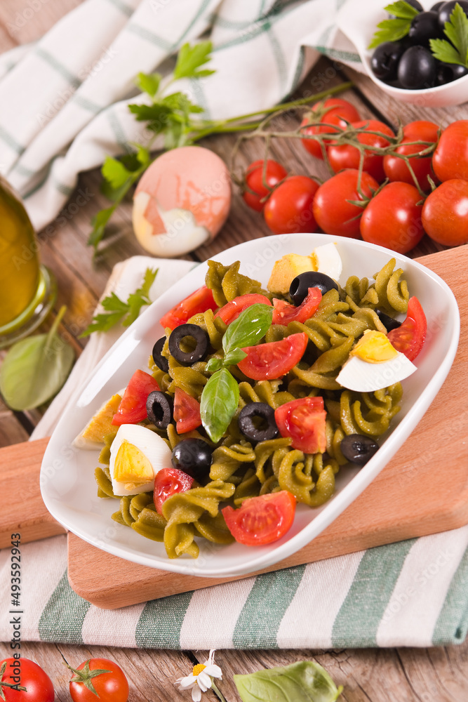 Fusilli pasta with cherry tomatoes, eggs and black olives. Fusilli pasta with cherry tomatoes, eggs and black olives.