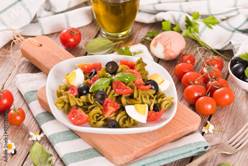 Fusilli pasta with cherry tomatoes  eggs and black olives.