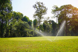 A large Golf course with a perfectly manicured lawn. The lawn needs watering. Lawn irrigation system on the Golf course.