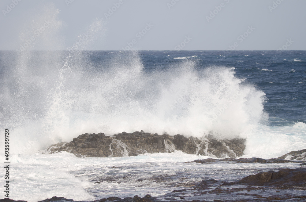 Wave breaking against the shore. El Confital. La Isleta Protected Landscape. Las Palmas de Gran Canaria. Gran Canaria. Canary Islands. Spain.