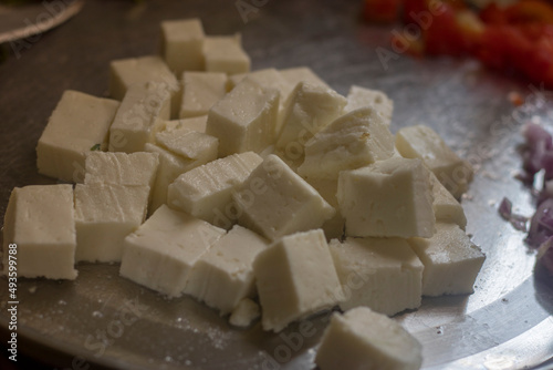 selective focus of cube pieces of Indian cheese.
