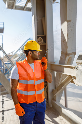 Construction industrial engineer with walkie-talkie at plant