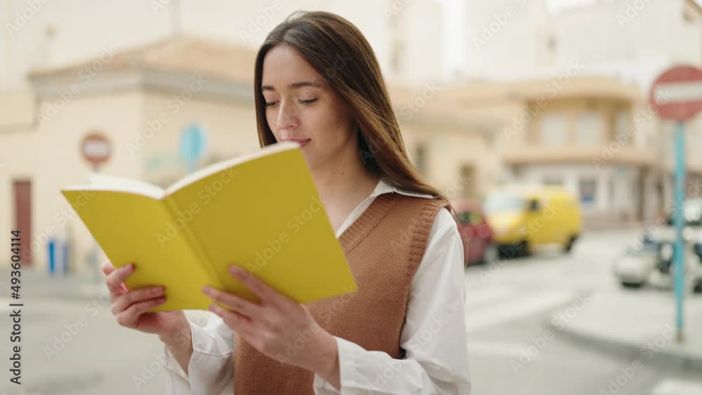 Young hispanic woman smiling confident reading book at street Young hispanic woman smiling confident reading book at street