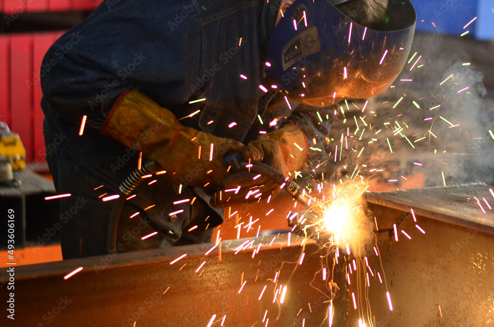 A welder works at a factory