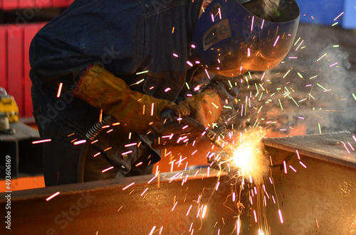 A welder works at a factory