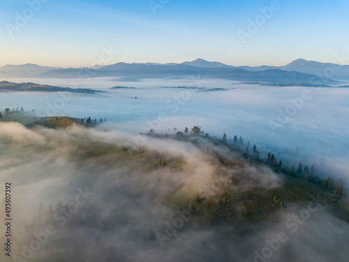 Morning mist in Ukrainian Carpathian mountains. Aerial drone view.