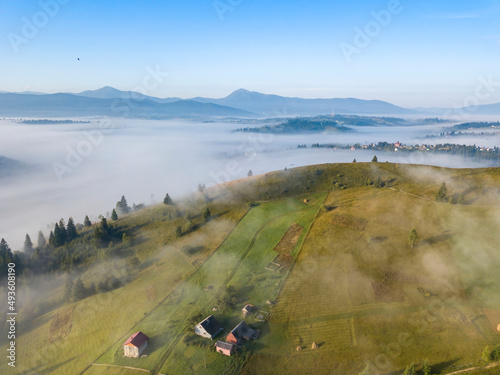 Morning mist in Ukrainian Carpathian mountains. Aerial drone view.