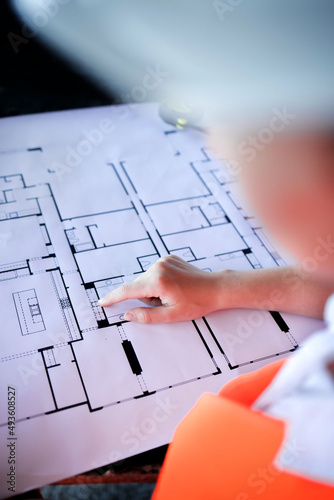 Architect working over plan. Closeup Desk With blueprints drawing.
