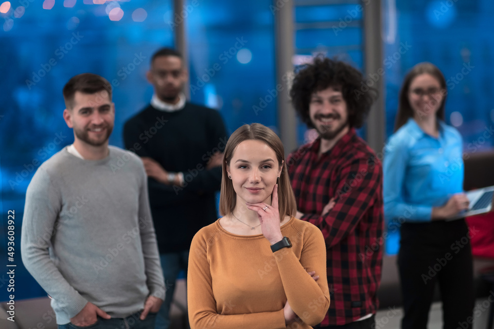 Portrait of successful creative business team looking at camera and smiling. Diverse business people standing together at startup. Selective focus Portrait of successful creative business team looking at camera and smiling. Diverse business people standing together at startup. Selective focus