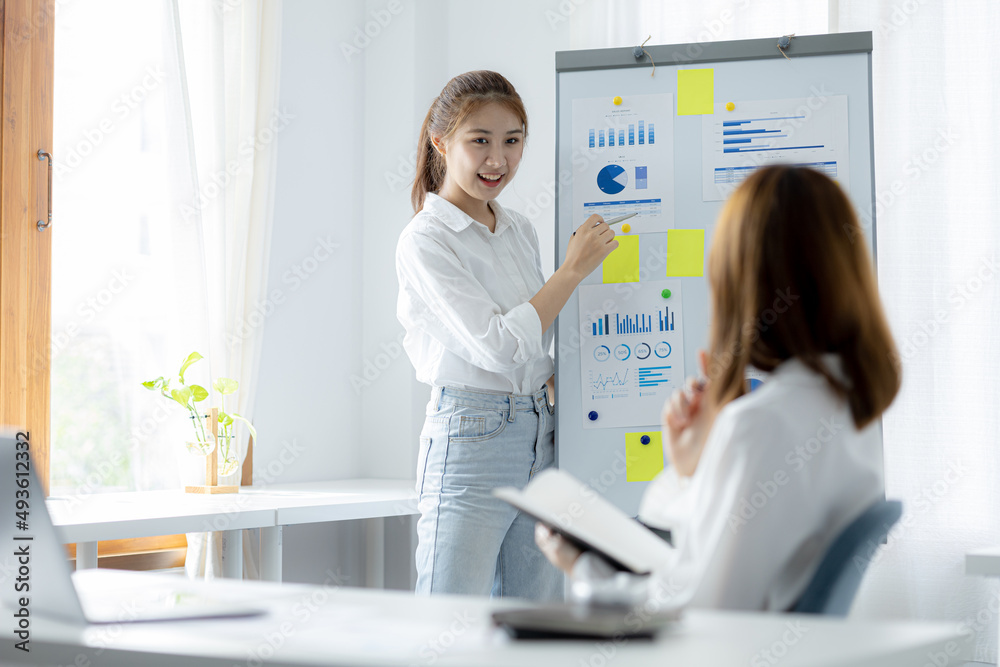 Atmosphere in the office of a startup company, two female employees are discussing, brainstorming ideas to work on summaries and marketing plans to increase sales and prepare reports to managers. Atmosphere in the office of a startup company, two female employees are discussing, brainstorming ideas to work on summaries and marketing plans to increase sales and prepare reports to managers.