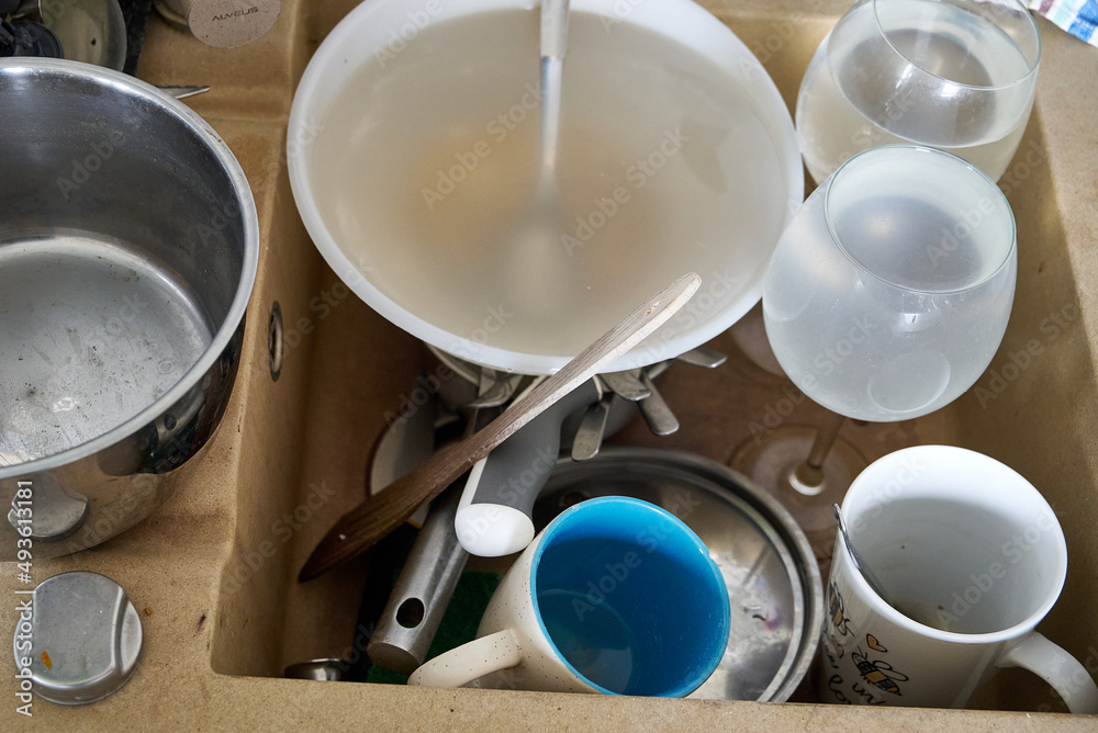 dirty dishes in the sink waiting to be washed