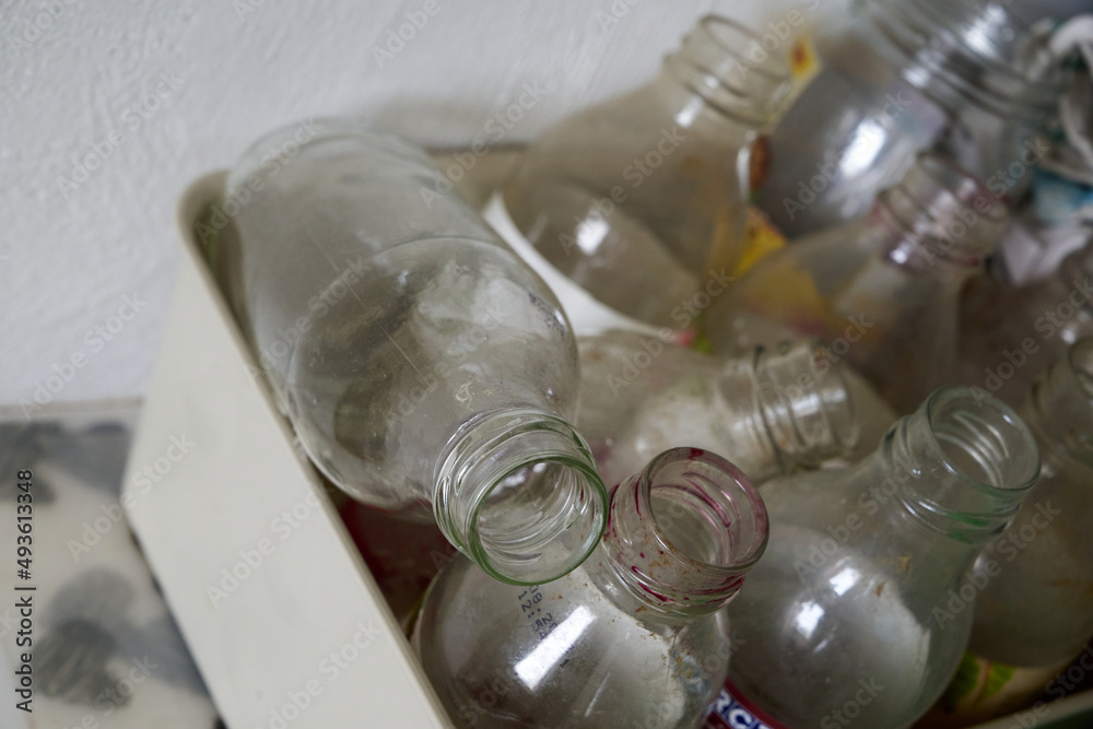 dirty, old, empty bottles in garbage segregation