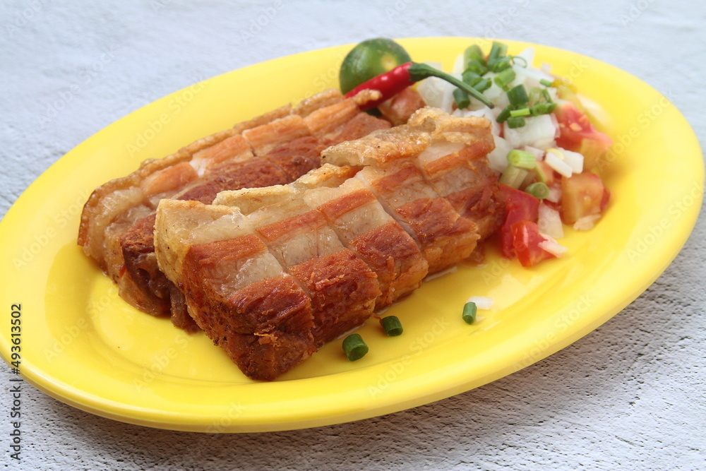 Freshly cooked Filipino food called Lechon Kawali or crispy deep fried pork belly Freshly cooked Filipino food called Lechon Kawali or crispy deep fried pork belly