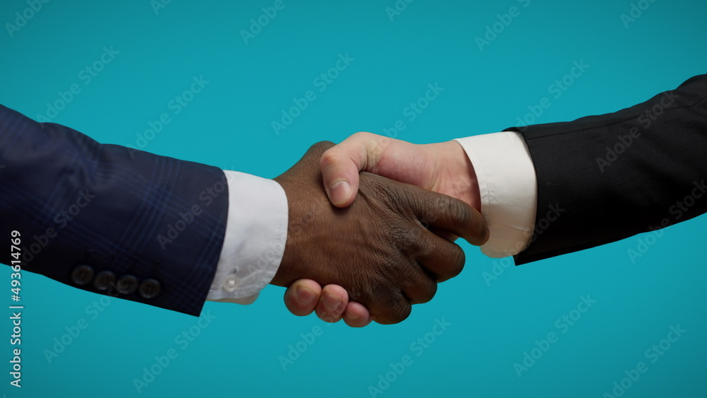 Male politicians shaking hands on blue background, international union, deal Male politicians shaking hands on blue background, international union, deal