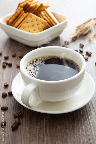 Hot coffee cup with smoke on the wooden background