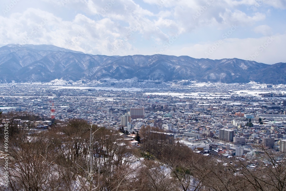 Landscape of Suwa city with snow covered mountains.