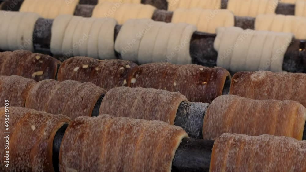 Rolling chimney cakes close up- Traditional sweets Rolling chimney cakes close up- Traditional sweets