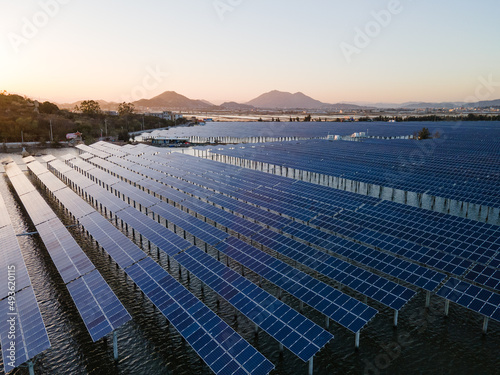 An aerial view of a solar power plant in the sea at sunset.New Energy Technology. Photovoltaic power generation. Energy Conservation and environmental protection.
