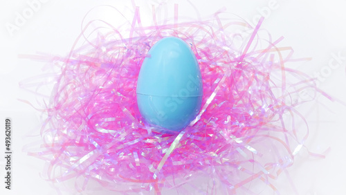 Blue easter egg on pink confetti 