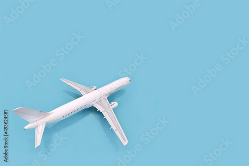 Three-dimensional model of a white plane on a blue background, 3d rendering © Mari_Piman