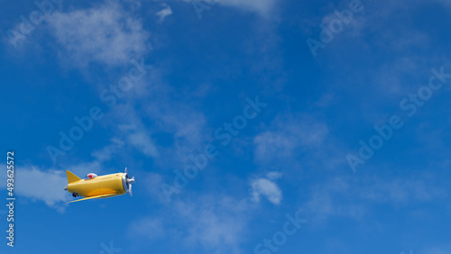3D render of little airplane flying over clear blue sky. Place for your text, design, banner or lettering