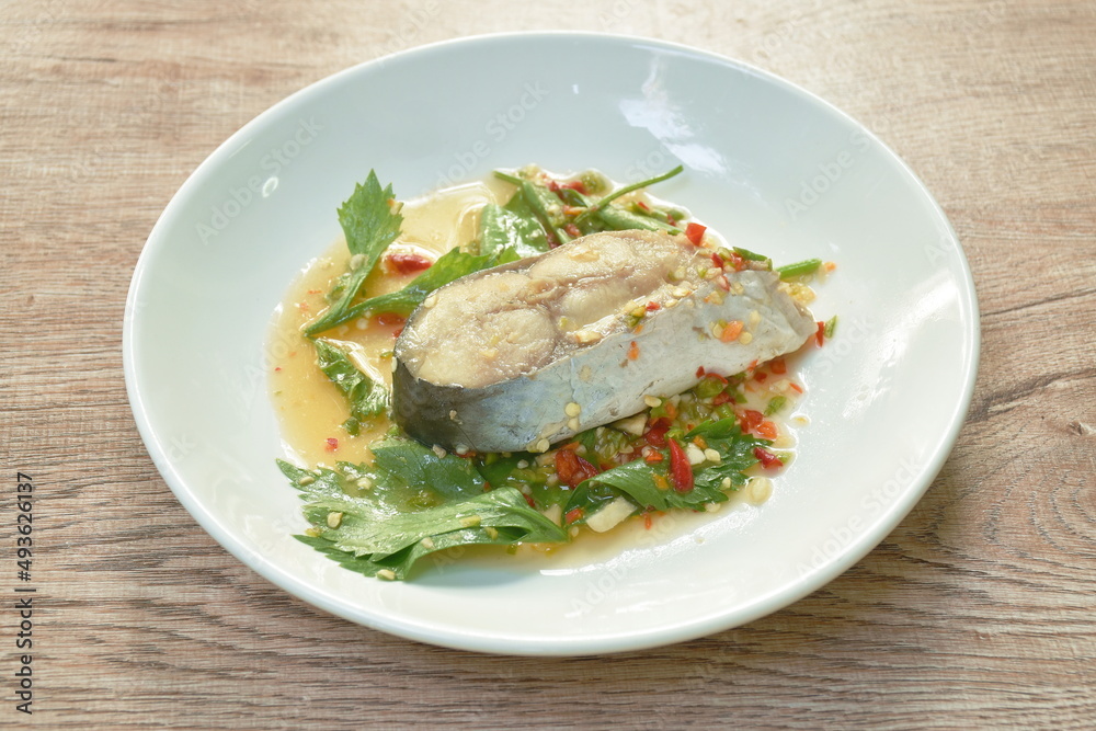 steamed dolly fish with chili and lemon dressings celery on plate steamed dolly fish with chili and lemon dressings celery on plate