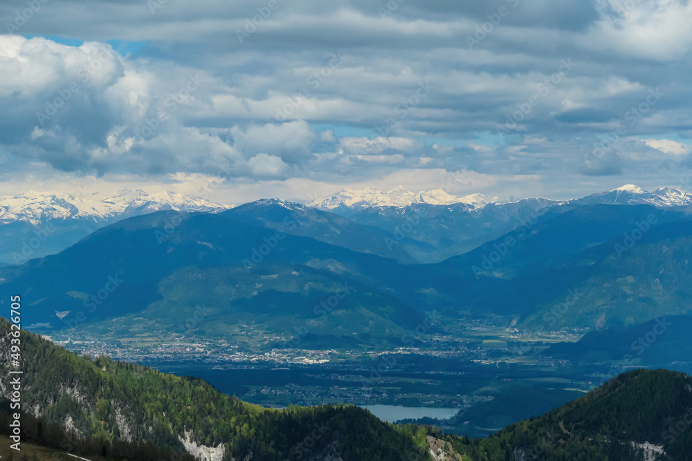 Mountain peak of Hahnkogel (Klek) with panoramic view in spring on the Karawanks, Carinthia, Austria. Borders Austria, Slovenia, Italy. Hohe Tauern Mountain Range. Alpine meadows