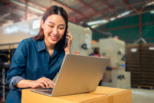 Business or owner or entrepreneur work in stock or warehouse industrial, businessman and woman use laptop computer or tablet for check inventory and logistic management.