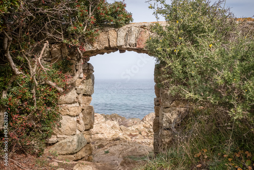 A stone doorway with a view through to the Mediterranean sea at Davia on the west coast of Corsica