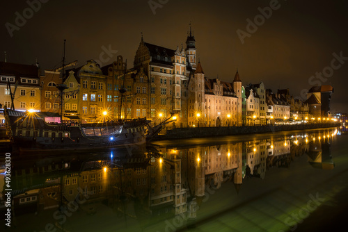 Nightshot of St Mary s Gate and Other Houses in the Old Town of Gdansk Reflecting in Motlawa River  Poland