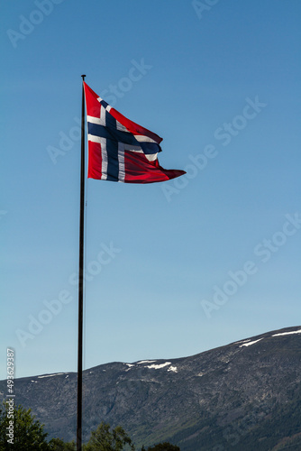 Spring scenery in Norway, with Norwegian national flag and mountains