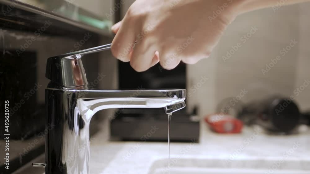 turn off stop the leaking tap water from the faucet in toilet. Save water save earth concept